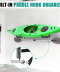 Built Like A Tank Wall Mount Kayak Storage Rack With Paddle Hooks holding a green kayak against a wall.