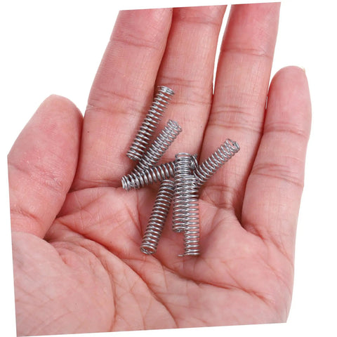 Get Your Hands On These 100 Pc Mini Stainless Steel Compression Springs, A Total Badass Kit For DIY Mechanics And Home Repairs That Makes Fixing Doors Cars And Metal Gadgets Super Easy And Quick. mini silver springs in hand