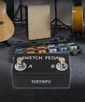 Momentary Dual Switches For Guitar Effect Pedal With TRS Cable in studio, aluminum shell, control for pedals and devices in background.