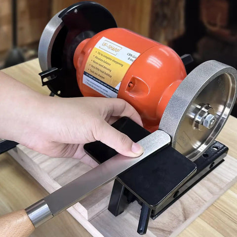 Heavy Duty Woodturning And Carving Tool Sharpening Jig For 6 Inch To 8 Inch Bench Grinders with a hand guiding a tool on the grinder.