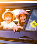 Children smiling from car window with Baby On Board Car Sign Pack, Two Window Stickers With Super Strong Double Suction Cups installed on window.