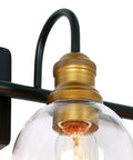 Close-up of 4 Light Modern Farmhouse Vanity Light Fixture in Black with Oil Rubbed Bronze Finish and Clear Globe Glass Shades.