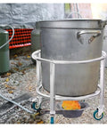 Kickass Heavy Duty Drum Rack And Commercial Soup Pot Trolley For Rolling 50 Cm Adjustable Barrels With Sturdy Steel Build holding a large stainless steel pot outdoors.