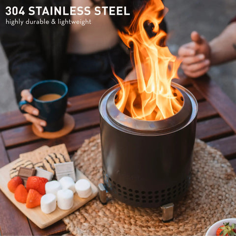Tabletop Smokeless Fire Pit With Stand 7 Inch Stainless Steel Bonfire For Camping And Patio, shown on a table with food.