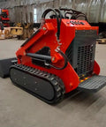 Front view of Compact Track Loader Skid Steer with Enclosed Cab and High Flow Hydraulics, shown on concrete floor in warehouse.