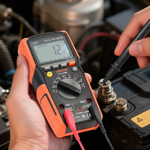 Hands using Digital Multimeter 6000 Count TRMS Auto Ranging For DC AC Voltage And Current Resistance Capacitance Testing on engine