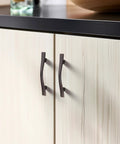 Five Pack 3 Inch Curved Oil Rubbed Bronze Cabinet Handles for kitchen cabinets with 3 inch center hole spacing, shown installed on doors.