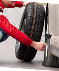 Spare Tire Bolt Retainer Clamp For Trucks And SUVs, Quick Release Hold Down Accessory being used on a roadside tire change.