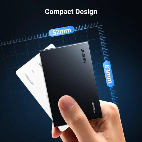 Hand holding compact UGREEN Ethernet Switch, 5 Port Gigabit Ethernet Splitter against measurement grid, highlighting dimensions.