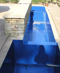 Sky Blue Non-Toxic Pond Shield Epoxy Paint 1.5-Quart applied on a rectangular pond, self-priming waterproof for fish and plants.