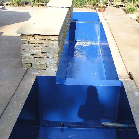 Sky Blue Non-Toxic Pond Shield Epoxy Paint 1.5-Quart applied on a rectangular pond, self-priming waterproof for fish and plants.