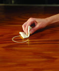 Hand using Reusable Water Mark Remover Cloth For Wood Care, Fix White Rings And Haze From Moisture And Heat on wooden surface