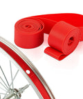 Red 18Mm Rim Tape Liner For 16 Inch Through 29 Inch Bikes, Tire Liner Rim Strip next to bicycle wheel showing application