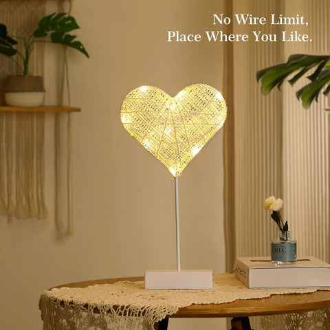 Heart Shaped Led Desk Lamp With Cotton Thread Glow, Battery Powered Night Light on a wooden table in a cozy bedroom setting.