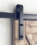 Hella Sturdy 7.5ft Sliding Barn Door Hardware Kit Smooth Gliding Track System For Single Doors No Fuss Heavy Duty Installation Matte Black Carbon Steel close-up of roller and track.