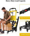 Man sitting on Heavy Duty Electric Stair Climber Hand Truck That Crushes 441 Lbs Loads With Ease, using a tablet.