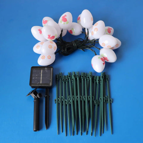 20 LED Solar Easter Egg Lights Outdoor Stake With 25 Ft Cord, 8 Modes Waterproof Yard Pathway Garden Lights For Easter Decor, Brighten Up Your Spring Vibe And Festive Backyard, showing egg lights and solar panel on blue background.