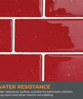 Close-up of red glossy peel and stick kitchen backsplash tiles with water droplets showing water resistance.