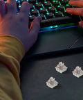 Top Tier Three Legged Linear Keyboard Switches Built Tough With Abs And Metal Housing For Smooth Gaming Setup Replacement, three switches on desk.