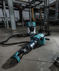 Badass Heavy Duty Eighty Volt Brushless Cordless Breaker Hammer with accessories on a concrete floor in a construction site.