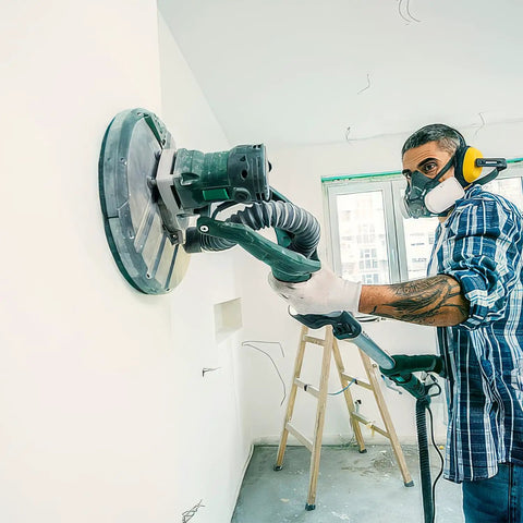 Person using a sander with Dust Free Pro Grade 25 Pack 9 Inch Mesh Sanding Discs Set With 60 80 120 180 240 Grits for drywall finishing