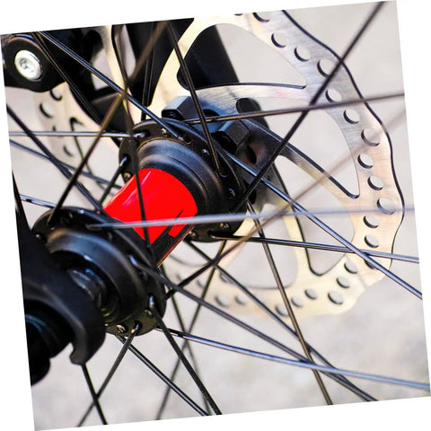 Close up of Heavy Duty Mountain Bike Disc Brake Kit with 160Mm rotor, black spokes, and red hub for rough terrain.