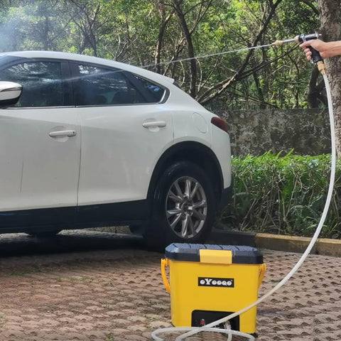 Using Compact Portable Pressure Washer With 5 Gallon Tank And 255 Psi For Easy Car Washes in a driveway setting.