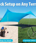 Ten By Ten Foot UPF50 Plus Beach Tent Sun Shelter with stakes and sandbags on beach and grass