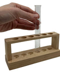 Hand placing test tube in Small Wooden Test Tube Rack For Six 15mm Tubes 6 Inch Long 2.7 Inch Tall Unfinished Oak Construction Economy Lab Rack