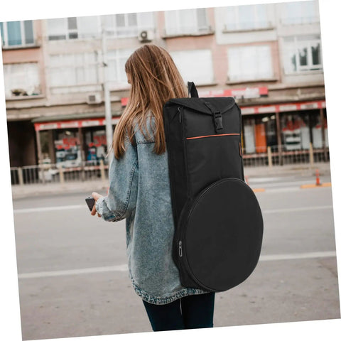 Female carrying Road Ready Portable Dumb Drum Bag For Silent Practice Pad Storage In Slick Oxford Fabric while walking in the street.