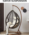 Ultimate Hanging Kit For Egg Hammock Chair With Steel Spring Pin Plug Hardware And 500Lb Capacity For Hanging Baskets Chairs Hammocks And Porch Swings Brown installed view in modern room with egg chair hung from stand.