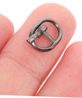 Close-up of a silver miniature alloy buckle from 150 Pcs Miniature Alloy Buckles For Doll Clothes Shoes Belts Quick Release Metal Fasteners For Sewing And DIY Craft Projects Silver And Black Durable Metal Construction For Long Lasting Use In Crafting And Doll Making