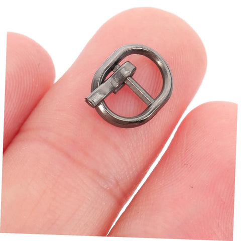 Close-up of a silver miniature alloy buckle from 150 Pcs Miniature Alloy Buckles For Doll Clothes Shoes Belts Quick Release Metal Fasteners For Sewing And DIY Craft Projects Silver And Black Durable Metal Construction For Long Lasting Use In Crafting And Doll Making