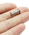 Rock Solid Chicago Binding Screws, M4 X 12Mm Phillips Pan Head Rivet Nuts held in hand, showcasing nickel plated carbon steel finish.
