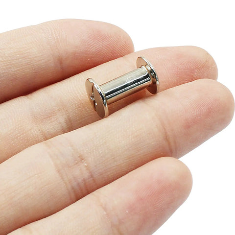 Rock Solid Chicago Binding Screws, M4 X 12Mm Phillips Pan Head Rivet Nuts held in hand, showcasing nickel plated carbon steel finish.
