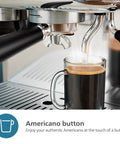 Semi Automatic Espresso Machine With Drip Free Barista Creations brewing Americano into glass cup with one touch button.