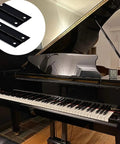 Two Pack Heavy Duty Black Piano Hinges 36 Inch Long By 2 Inch Open Width, Stainless Steel Continuous Hinge next to a grand piano