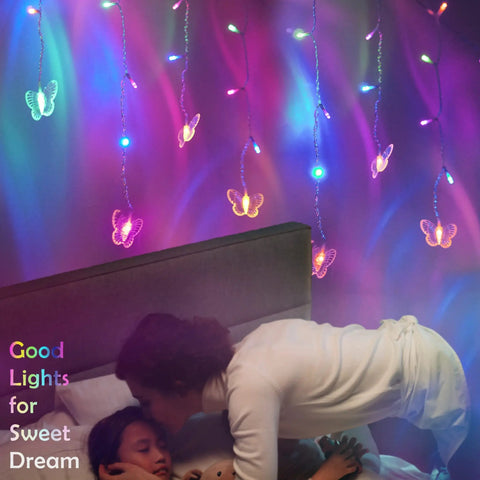 120 LED Butterfly Curtain Fairy Lights Lit USB Powered 6M 19.7ft With Remote Timer 8 Modes Waterproof Indoor Outdoor Decor for Kids Bedroom Christmas Wedding Party Dorm Multicolor glowing above a child sleeping in bed, creating a serene atmosphere.