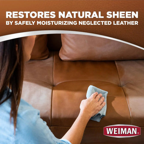 Person using Top Shelf Leather Cleaner And Conditioner Wipes on a brown leather sofa to restore its natural sheen.