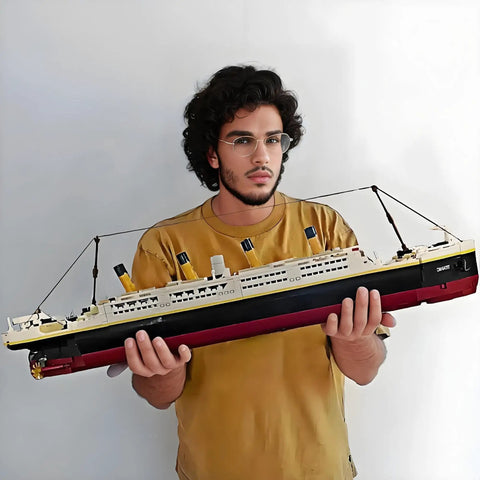 Epic Titanic Model Kit With 2022 Building Blocks, Giant 26.97 Inch Replica Ship, STEM 3D Puzzle Toy For Kids And Adults, Educational Collectible Display For Home Or Office Decor, Realistic Bow, Funnel, And Propeller Detail, held by man