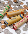 Easy Coin Sorter Tube Set With Wrappers, 5 in 1 Change Counter Machine showing wrapped coin tubes surrounded by scattered coins