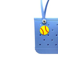 Softball Ball Tote Bag Charm With Team Spirit on a blue tote, durable decorative accessory for Bogg Bags, made in USA, easy clip-on.