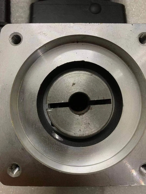 Planetary gearbox gearhead front view; silver aluminum housing with central shaft bore and keyway, four mounting holes