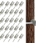 25-pack porcelain electric fence insulators with lag screws for wood posts; installed on a wooden post.