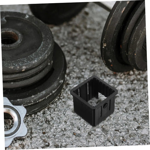 Rock Solid Fitness Tube Sleeves Four Pack Built Tough Hollow Pipe Bushings For Gym Adapter 50mm To 40mm laying beside weight plates.