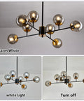 Eight Light Mid Century Glass Globe Chandelier with gold finish, shown in warm white, white light, and turned off lighting modes.