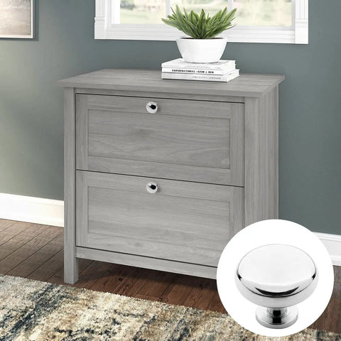 5 Pack Polished Chrome Cabinet Knobs on a gray two-drawer cabinet. Round handles suitable for kitchen and bathroom.
