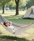 Woman relaxing outdoors in Vintage Bathtub Camping Hammock, Ultra Lightweight And Portable, Heavy Duty 330 Lb Capacity