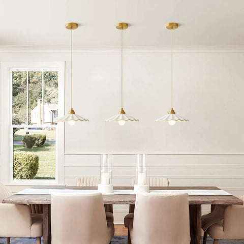 Premium White Scalloped Ceramic Pendant Light Adding Sweet Vintage Charm To Kitchen Islands with gold fittings above a dining table.