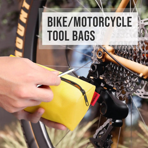 Hand holding yellow pouch from Rugged Five Pack Tool Pouches Set With 1680D Waterproof Fabric, near bike gear.